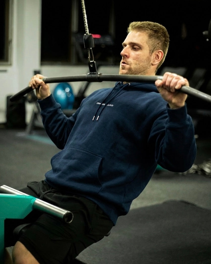Man in a navy chasing aesthetics legacy hoodie